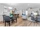 Bright open-concept living and kitchen area featuring modern decor, wood floors, and natural light at 8703 Driftwood Dr, Tampa, FL 33615