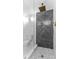 Sleek shower with herringbone tile, rainfall showerhead, and modern fixtures for a luxurious experience at 8703 Driftwood Dr, Tampa, FL 33615