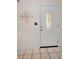 Bright entryway featuring tile flooring and a decorative door at 1120 Idlewild N Dr, Dunedin, FL 34698