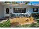 Inviting front porch with decorative seating area at 1120 Idlewild N Dr, Dunedin, FL 34698