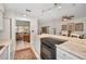 Bright kitchen area showcasing stainless steel appliances, stone countertops, and breakfast bar, perfect for casual dining at 1120 Idlewild N Dr, Dunedin, FL 34698