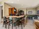 Bar area featuring seating, cabinets, bar sink, TV and open access to seating area at 12700 Grand Traverse Dr, Dade City, FL 33525