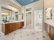 Bathroom with dual vanities, tile flooring and a separate toilet area for convenience at 12700 Grand Traverse Dr, Dade City, FL 33525