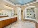 Spacious bathroom with a large tub, tiled floors, dual vanity and beautiful architectural design at 12700 Grand Traverse Dr, Dade City, FL 33525