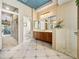 Bathroom featuring a walk-in shower, tile flooring, blue ceiling and a wooden vanity at 12700 Grand Traverse Dr, Dade City, FL 33525