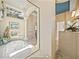 Bathroom with a soaking tub, elegant columns and a large mirror to add dimension at 12700 Grand Traverse Dr, Dade City, FL 33525