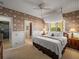 Cozy bedroom with a nautical theme and comfortable bed; leads to an en suite bathroom for added convenience at 12700 Grand Traverse Dr, Dade City, FL 33525