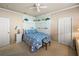 Cozy bedroom featuring unique wallpaper, a comfortable bed, and ample closet space at 12700 Grand Traverse Dr, Dade City, FL 33525