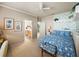 Bedroom showcasing a blue bed set, complemented by patterned walls and an ensuite bath at 12700 Grand Traverse Dr, Dade City, FL 33525