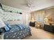 Comfortable bedroom featuring charming wallpaper, furnishings, and a ceiling fan at 12700 Grand Traverse Dr, Dade City, FL 33525