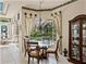Cozy dining nook with a view of the screened in pool area and yard at 12700 Grand Traverse Dr, Dade City, FL 33525