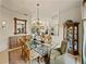 Formal dining room featuring a glass table and elegant decor at 12700 Grand Traverse Dr, Dade City, FL 33525