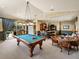 Game room featuring a pool table, bar area and plenty of space for entertainment at 12700 Grand Traverse Dr, Dade City, FL 33525