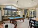 Game room featuring a pool table, window seating and a door leading to an outdoor space at 12700 Grand Traverse Dr, Dade City, FL 33525