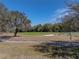 Beautifully landscaped golf course featuring mature trees and a manicured green at 12700 Grand Traverse Dr, Dade City, FL 33525