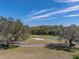 Scenic view of a well-maintained golf course with mature trees and clear blue sky at 12700 Grand Traverse Dr, Dade City, FL 33525