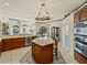 Bright kitchen featuring an island, wood cabinets, stainless appliances, and an adjacent dining nook at 12700 Grand Traverse Dr, Dade City, FL 33525