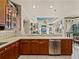 Bright kitchen featuring wood cabinets, stainless appliances, and a breakfast bar at 12700 Grand Traverse Dr, Dade City, FL 33525