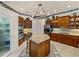 Kitchen with a central island, dark wood cabinetry, and stainless steel appliances at 12700 Grand Traverse Dr, Dade City, FL 33525