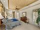 Elegant main bedroom features a tray ceiling, luxurious bedding, furniture and lots of space at 12700 Grand Traverse Dr, Dade City, FL 33525