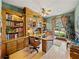 Inviting office space with beautiful built-in bookshelves, a large window, and plenty of natural light at 12700 Grand Traverse Dr, Dade City, FL 33525