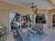 The covered lanai has an outdoor seating area and ceiling fan, which opens to the home's interior through large sliding doors at 12700 Grand Traverse Dr, Dade City, FL 33525