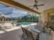 Covered, screened pool area with lush landscaping and comfortable outdoor seating at 12700 Grand Traverse Dr, Dade City, FL 33525