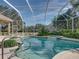 Screened-in pool offering a refreshing view of the backyard, golf course, and surrounding landscape at 12700 Grand Traverse Dr, Dade City, FL 33525