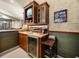 Beautiful wet bar featuring upper cabinets, sink, refrigerator, and countertop seating, perfect for entertaining guests at 12700 Grand Traverse Dr, Dade City, FL 33525