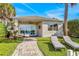 Outdoor patio featuring pavers, lounge chairs, and sliding glass doors to the interior at 2026 20Th Avenue Pkwy, Indian Rocks Beach, FL 33785