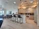 Open concept kitchen with barstool seating, modern appliances, and decorative light fixtures at 2026 20Th Avenue Pkwy, Indian Rocks Beach, FL 33785