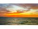 Beautiful sunset on the water with orange and yellow hued clouds and a calm ocean at 2026 20Th Avenue Pkwy, Indian Rocks Beach, FL 33785