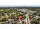 An aerial view showcases a neighborhood, railroad tracks, a cityscape, and a prominent house marker at 4223 E Emma St, Tampa, FL 33610