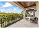 Large balcony featuring seating with views of lush tropical greenery at 4902 Carranza Ct, Tampa, FL 33616