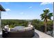 An outdoor living area with comfortable lounge seating provides peaceful views of the water and tree line at 4902 Carranza Ct, Tampa, FL 33616