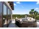 Open air balcony with circular couch and table overlooking nature at 4902 Carranza Ct, Tampa, FL 33616