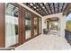 Expansive balcony with pergola and lounge seating, overlooking a lush, tropical landscape at 4902 Carranza Ct, Tampa, FL 33616