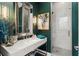 An elegant bathroom with a marble countertop, modern fixtures, and a glass-enclosed shower at 4902 Carranza Ct, Tampa, FL 33616