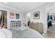 Cozy bedroom with wood dresser, neutral walls, and an adjacent walk-in closet and ensuite bathroom at 4902 Carranza Ct, Tampa, FL 33616