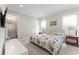 Bedroom with floral comforter, dual nightstands, and an ensuite bathroom with a gray vanity at 4902 Carranza Ct, Tampa, FL 33616