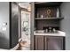 A stylish coffee bar features marble counters, shelves, and cabinetry at 4902 Carranza Ct, Tampa, FL 33616