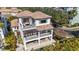 Stunning three-story home showcasing multiple balconies, a tile roof, lush landscaping, and a private pool at 4902 Carranza Ct, Tampa, FL 33616