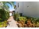 Landscaped walkway to home's entrance with well-maintained bushes and colorful foliage at 4902 Carranza Ct, Tampa, FL 33616