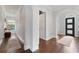 Hallway featuring dark hardwood floors, arched doorways and a window with view of the outdoors at 4902 Carranza Ct, Tampa, FL 33616