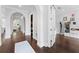 Bright hallway with white walls, hardwood floors, and elegant arched doorways leading to other rooms at 4902 Carranza Ct, Tampa, FL 33616