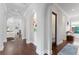Hallway with hardwood floors, decorative artwork, and archways leading to the living spaces at 4902 Carranza Ct, Tampa, FL 33616