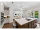 Open-concept kitchen with an island, pendant lighting, and seamless flow to the living room and outdoor area at 4902 Carranza Ct, Tampa, FL 33616
