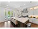 Bright and airy kitchen with a large center island, modern appliances, and access to outdoor patio at 4902 Carranza Ct, Tampa, FL 33616