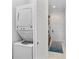 Efficient laundry area features a stacked washer and dryer with additional storage space at 4902 Carranza Ct, Tampa, FL 33616