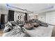 Spacious living room with a massive gray sectional and stylish decor, perfect for entertaining at 4902 Carranza Ct, Tampa, FL 33616